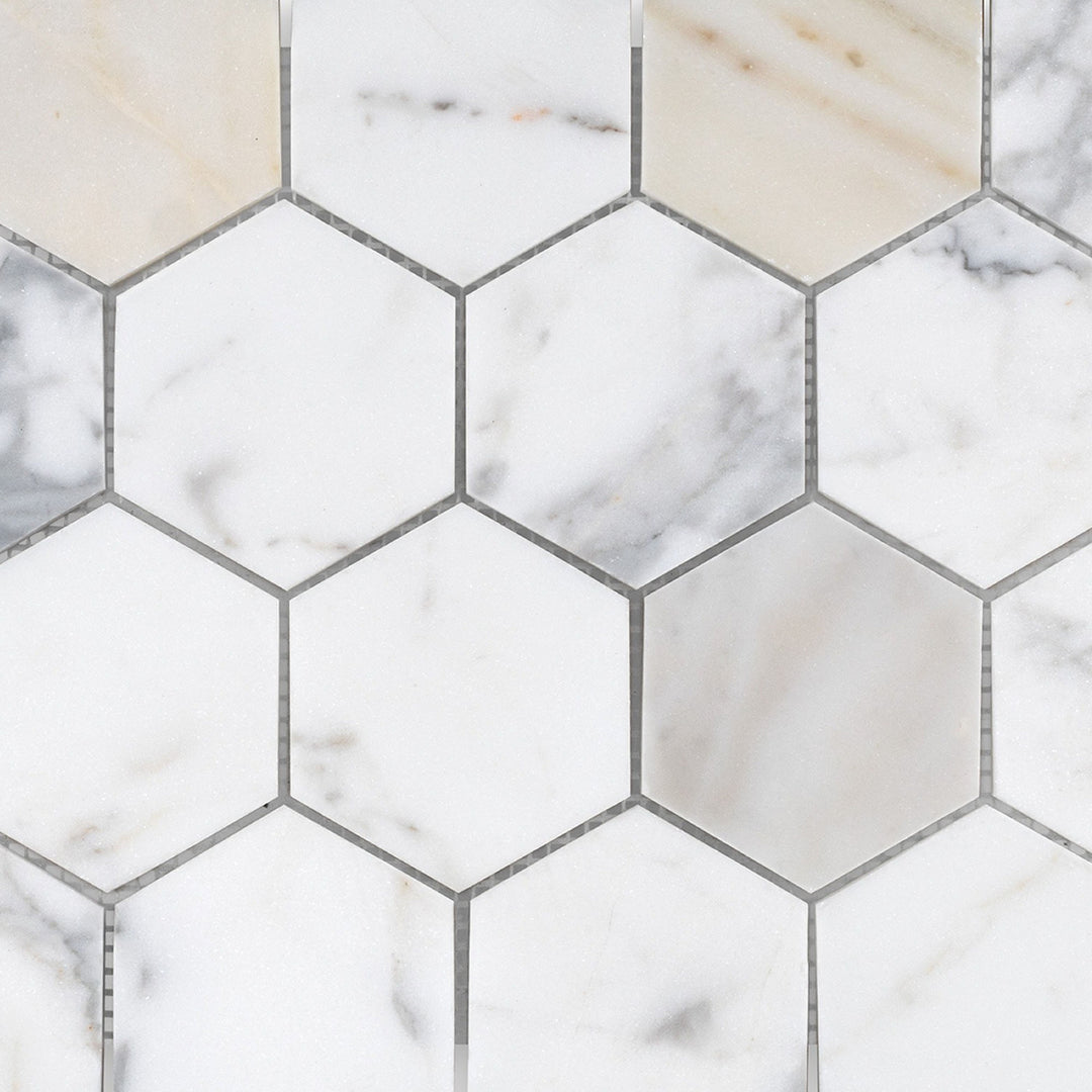 Detailed view of Calacatta Gold Marble 3" hexagon honed mosaic featuring larger scale geometry and muted elegance.