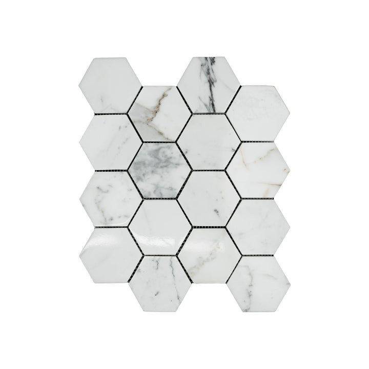 This top-down shot captures the polished Calacatta Gold Marble 3 inch hexagon mosaic, highlighting the natural shine and dramatic gold veining.