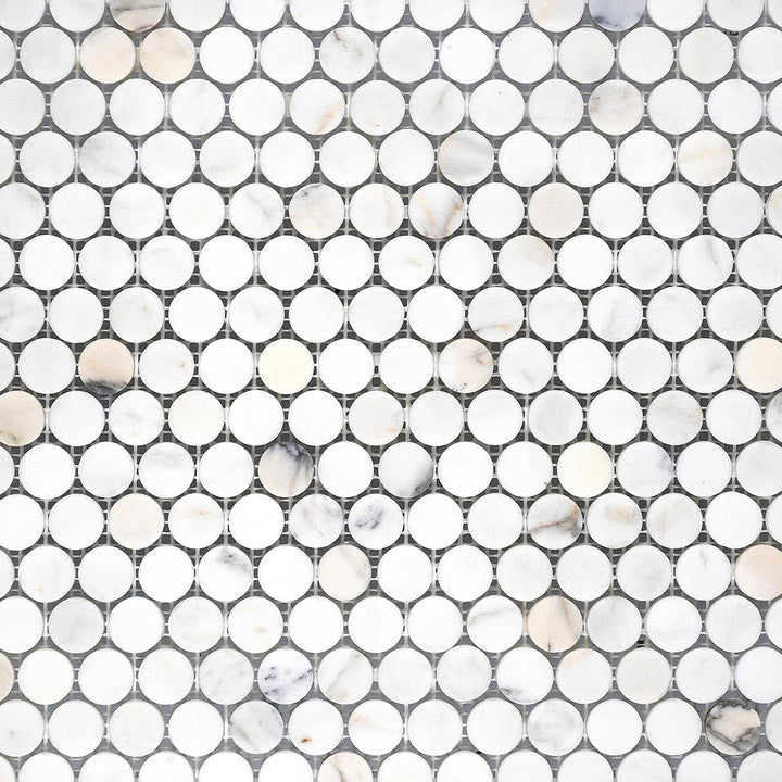 Calacatta Gold Marble penny round honed mosaic tiles laid out in a classic circular grid with a soft matte finish.