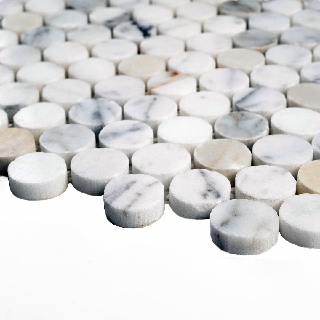 Polished Calacatta Gold penny round mosaic captured from the side, with gleaming surfaces and classic marble character in rounded form.