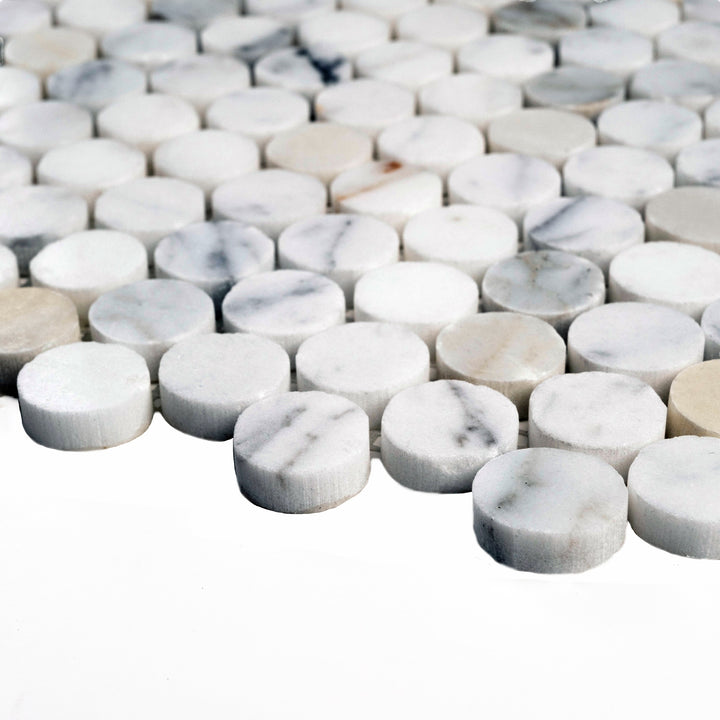 Polished Calacatta Gold penny round mosaic captured from the side, with gleaming surfaces and classic marble character in rounded form.