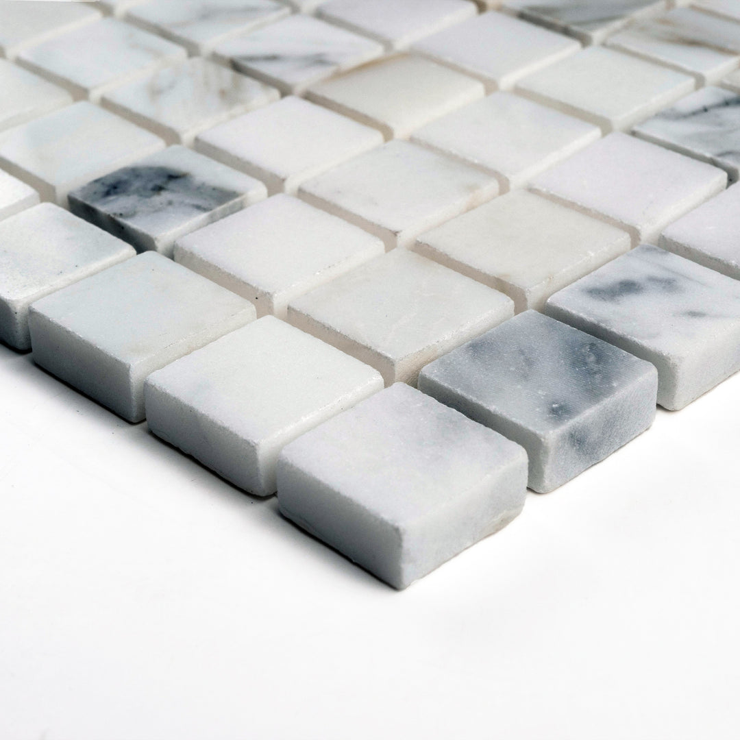 Side angle of 5/8" square polished Calacatta Gold mosaic, with crisp edges and a bright finish that reflects natural gold-white tones.