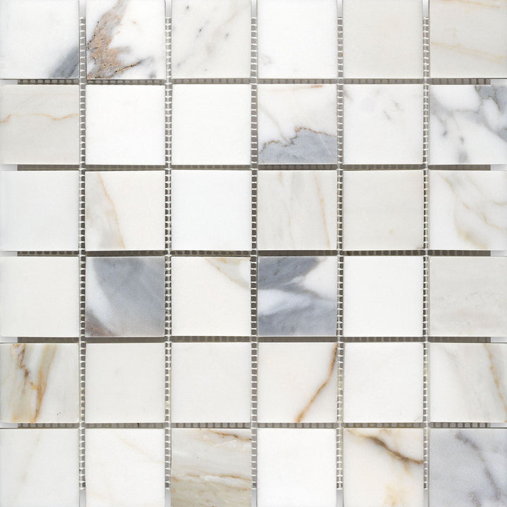 Wide layout of 2" square honed Calacatta Gold Marble mosaic showing balanced spacing and neutral tones.