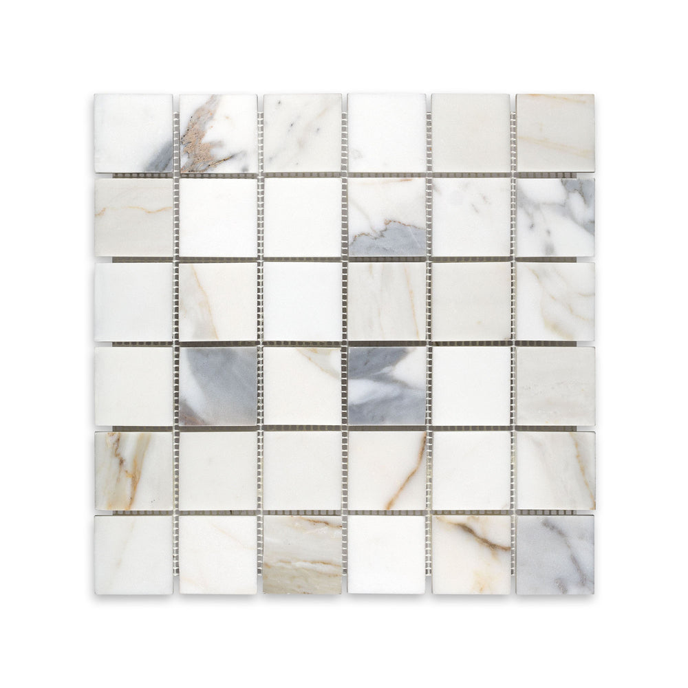 Overhead shot of 2 inch square Calacatta Gold Marble mosaic in honed finish, perfect for timeless tile applications with broad veining detail.