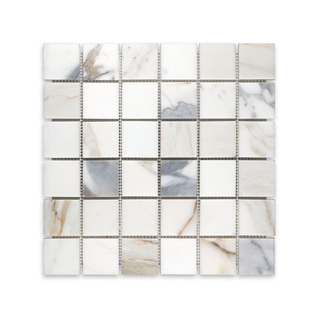 Overhead shot of 2 inch square Calacatta Gold Marble mosaic in honed finish, perfect for timeless tile applications with broad veining detail.