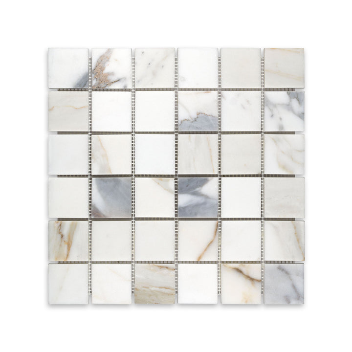 Overhead shot of 2 inch square Calacatta Gold Marble mosaic in honed finish, perfect for timeless tile applications with broad veining detail.