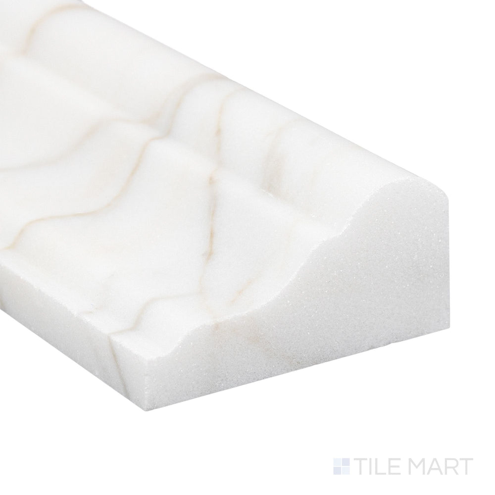 Corner close-up of Calacatta Gold Marble 2x12 honed grand chair rail showing smooth matte surface and natural tone.