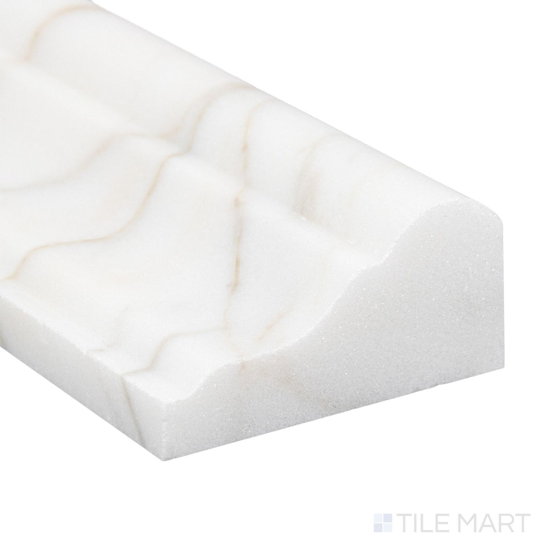 Corner close-up of Calacatta Gold Marble 2x12 honed grand chair rail showing smooth matte surface and natural tone.