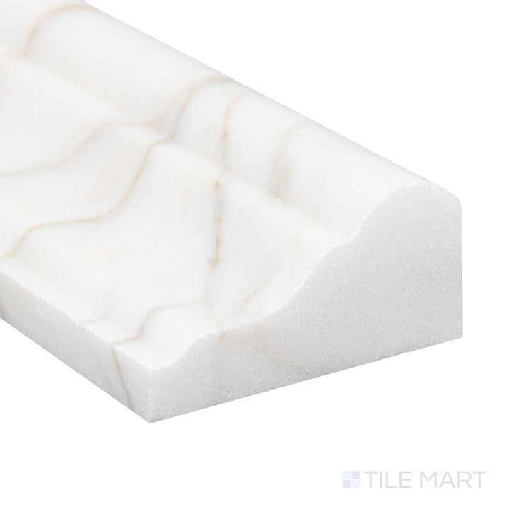 Corner close-up of Calacatta Gold Marble 2x12 honed grand chair rail showing smooth matte surface and natural tone.