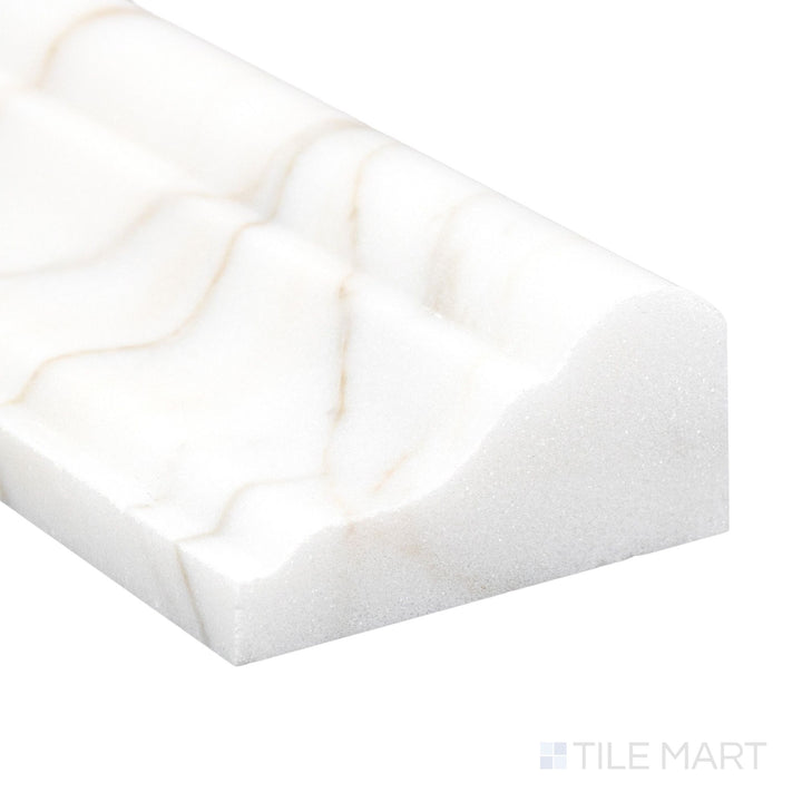 Corner detail of Calacatta Gold Marble 2x12 polished grand chair rail highlighting glossy finish and bold gold veining.