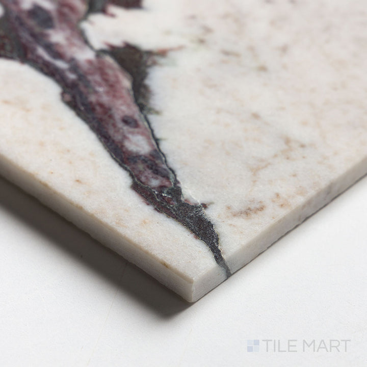 Corner close-up of Calacatta Viola Marble 12x24 honed tile showing soft matte texture and bold violet veining.