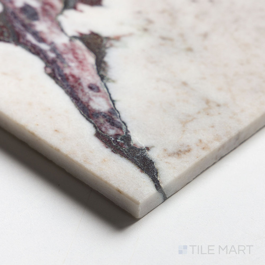 Corner detail of Calacatta Viola Marble 12x24 polished tile highlighting glossy surface and dramatic purple veins.
