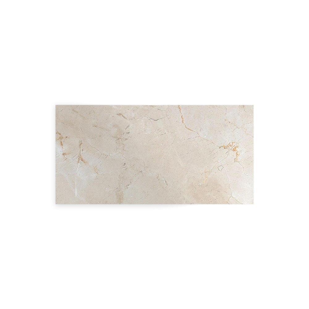 Overhead image of Crema Marfil Classic Marble 3x6 tile with a polished finish, offering a sleek reflective surface and natural veining on creamy stone.