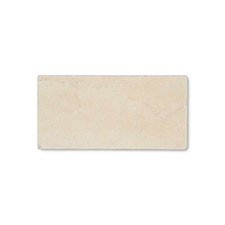 Seen from above, the Crema Marfil Classic Marble 3x6 tumbled tile showcases a textured, rustic finish with soft edges and warm neutral color.