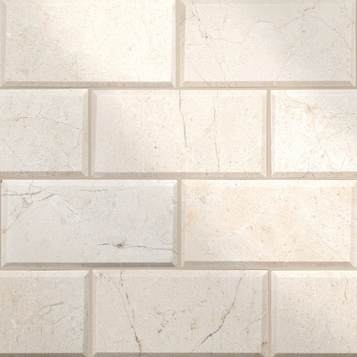 Full layout of 3x6 beveled polished Crema Marfil Classic Marble tiles emphasizing crisp edges and glossy surfaces.