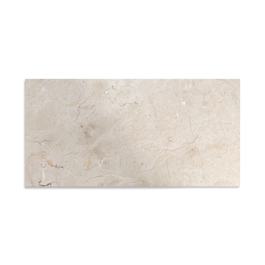 Polished 12x24 Crema Marfil Classic Marble tile captured from a top-down view, highlighting luxurious shine and delicate marble patterning.