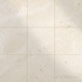 Glossy 12x12 polished Crema Marfil Select Marble tiles arranged to capture light and enhance classic stone texture.