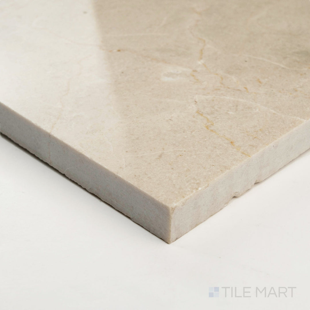 Corner detail of Crema Marfil Select Marble 12x24 polished tile highlighting glossy sheen and elegant marble veining.