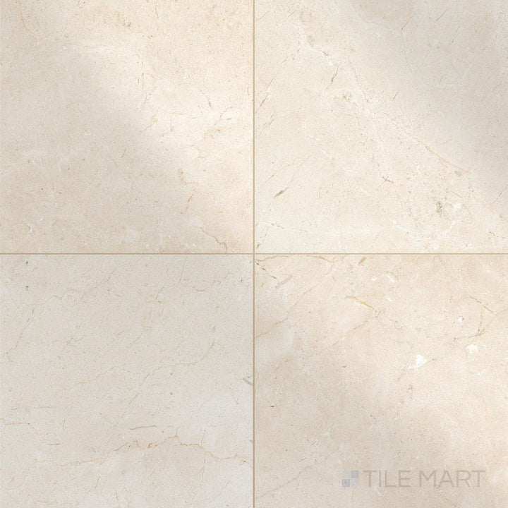 Polished 18x18 Crema Marfil Select Marble tiles in a top view grid showcasing surface sheen and uniformity.