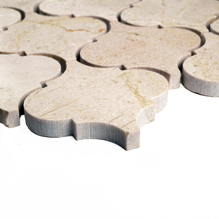 Honed 3 inch lantern Crema Marfil marble mosaic shown from a corner angle, highlighting its timeless Moroccan-inspired shape and soft matte texture.