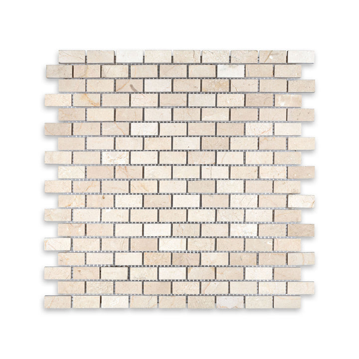 Top-down shot of 5/8 by 1-1/4 Crema Marfil Marble brick mosaic in honed finish, showcasing tight rectangular pattern and muted natural tones.