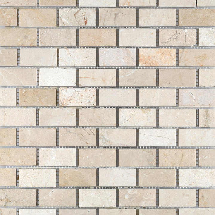 1x2 brick honed mosaic made from Crema Marfil Marble shown in grid layout highlighting its warm, natural stone surface.