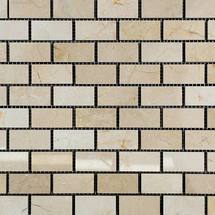 Crema Marfil Marble 1x2 polished brick mosaic tiles organized to reflect light across a soft beige palette.