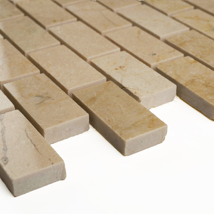 Polished 1x2 Crema Marfil brick mosaic shown corner-on, with elegant beige hues and a refined glossy finish.