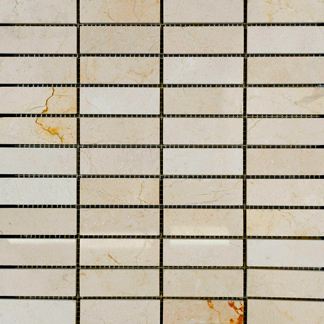 1x3 stacked polished mosaic tiles of Crema Marfil Marble laid in a clean format to highlight sheen and consistent beige coloration.