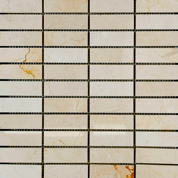 1x3 stacked polished mosaic tiles of Crema Marfil Marble laid in a clean format to highlight sheen and consistent beige coloration.