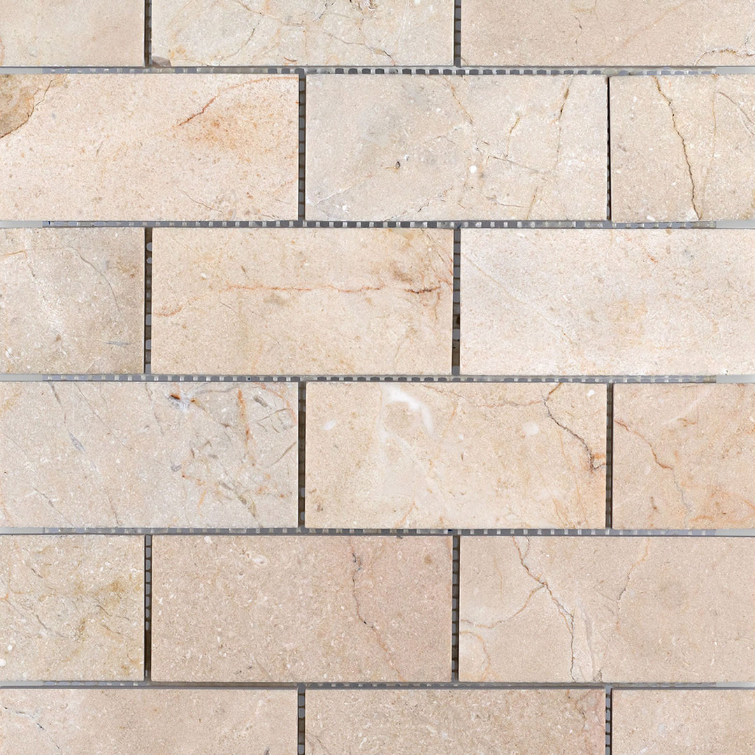 Crema Marfil Marble 2x4 brick honed mosaic tiles arranged to show smooth texture and classic rectangular layout.