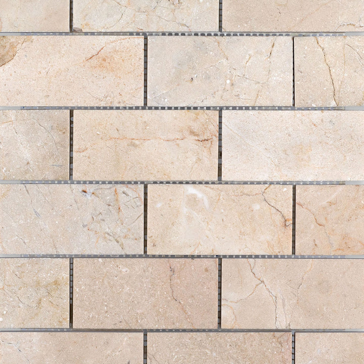 Crema Marfil Marble 2x4 brick honed mosaic tiles arranged to show smooth texture and classic rectangular layout.