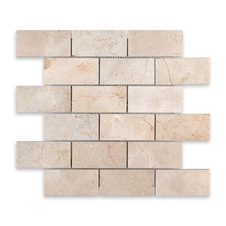 Crema Marfil Marble 2x4 brick mosaic in honed finish shown from a top-down view, offering a balanced pattern with natural tones and a smooth surface.