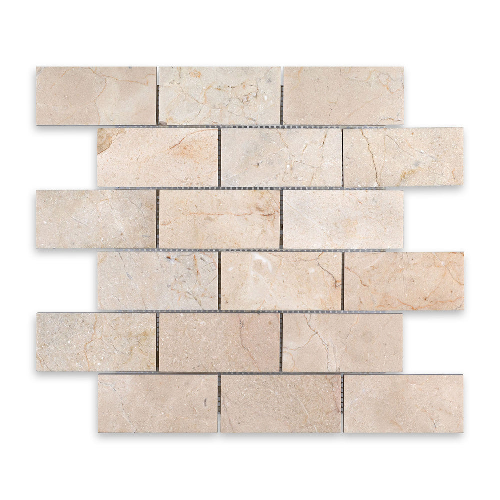 Crema Marfil Marble 2x4 brick mosaic in honed finish shown from a top-down view, offering a balanced pattern with natural tones and a smooth surface.
