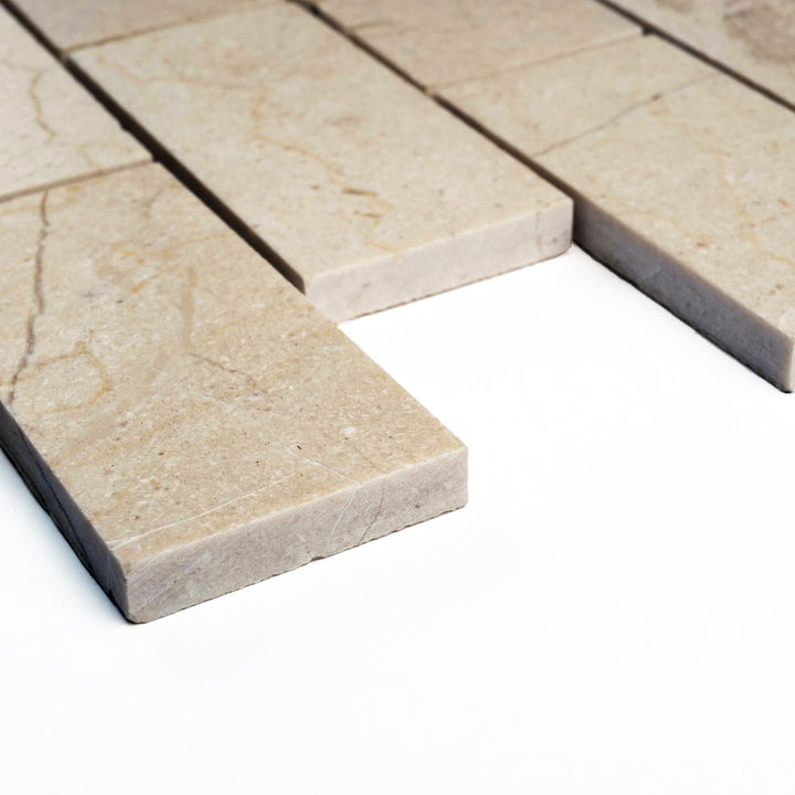 Honed 2x4 Crema Marfil brick mosaic seen from a corner angle, showing the elegant beige tones and balanced rectangular layout in a matte finish.