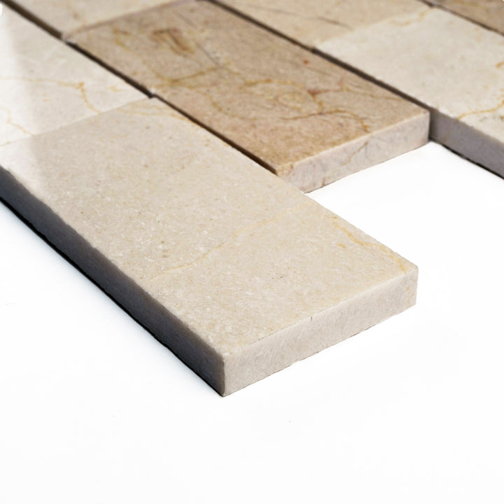 Polished 2x4 Crema Marfil brick mosaic displayed from a side perspective, highlighting its classic subway style and smooth reflective surface.