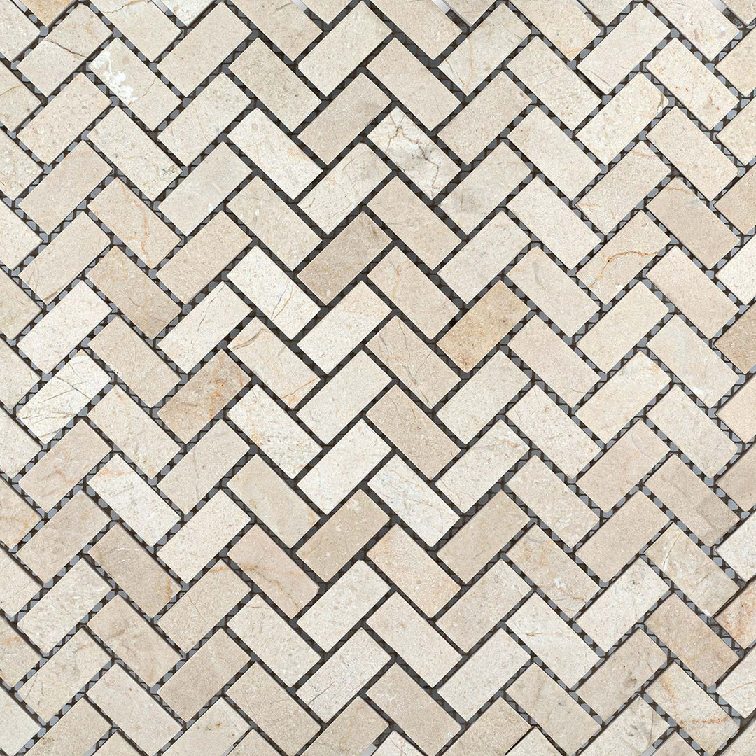 Overview of 5/8x1-1/4 herringbone mosaic using honed Crema Marfil Marble, laid in a woven format for classic elegance.