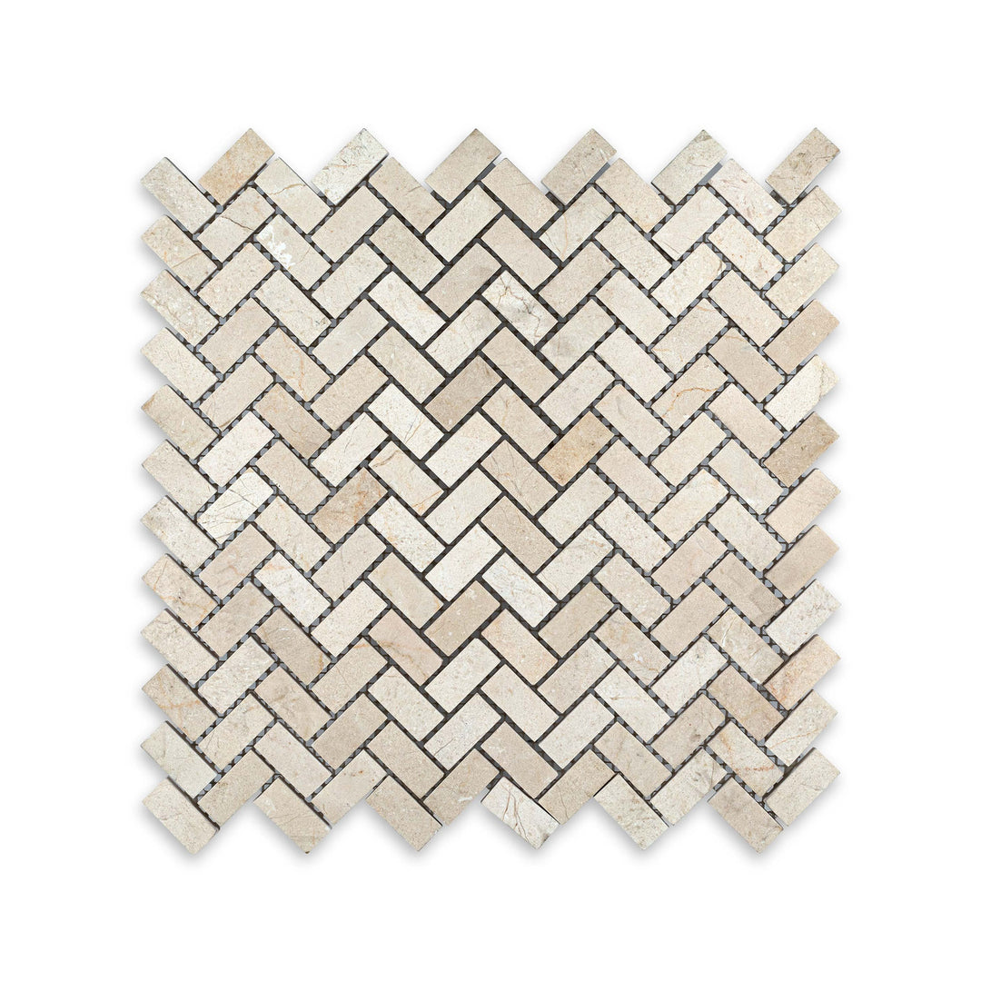 Top-view of 5/8 by 1-1/4 Crema Marfil Marble herringbone mosaic in honed finish, with tight interlocking design and soft matte appeal.