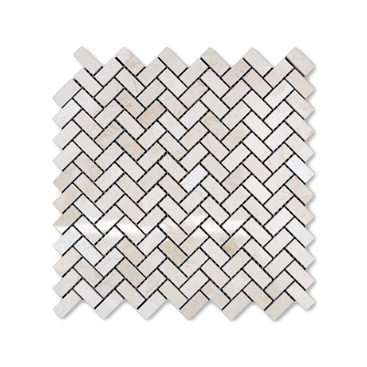 Polished 5/8 by 1-1/4 Crema Marfil Marble herringbone mosaic viewed from above, combining small-scale pattern with a glossy marble finish.
