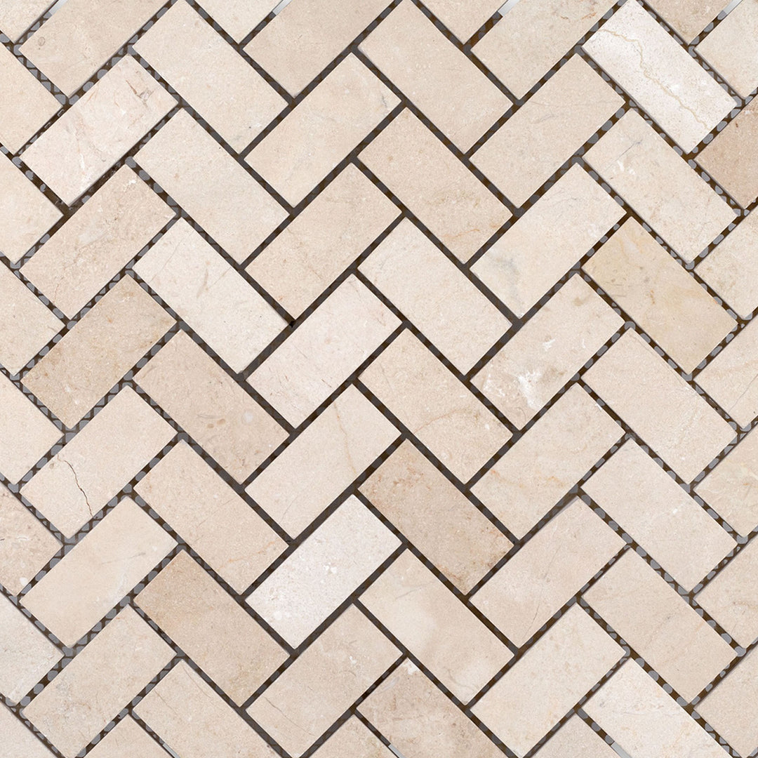 Crema Marfil Marble 1x2 herringbone honed mosaic displayed in a zigzag layout with a soft matte stone finish.
