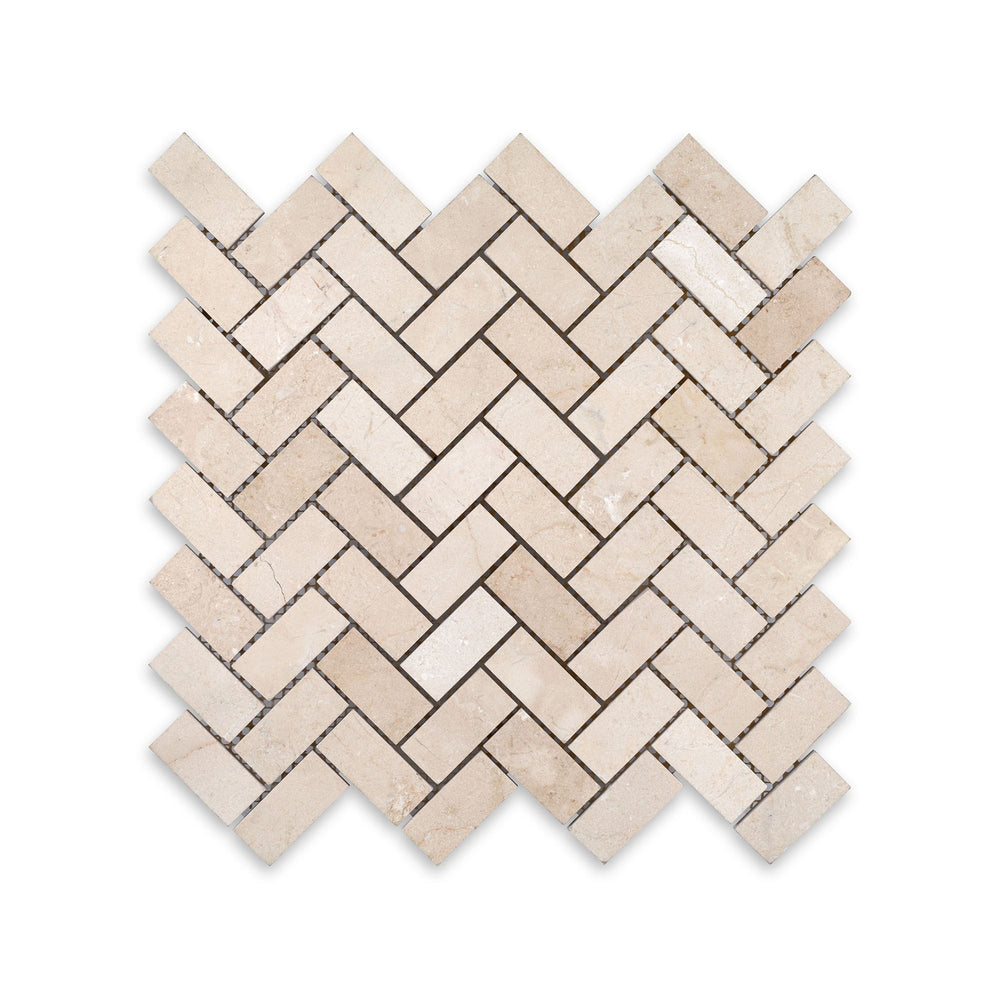 Overhead image of 1x2 herringbone mosaic in honed Crema Marfil Marble, offering subtle veining and a timeless diagonal layout.