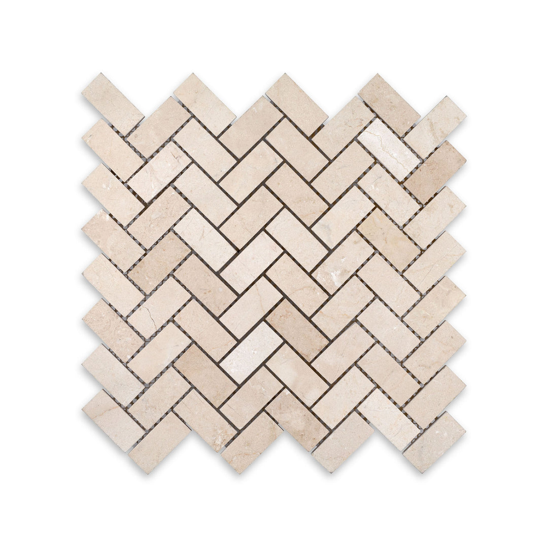 Overhead image of 1x2 herringbone mosaic in honed Crema Marfil Marble, offering subtle veining and a timeless diagonal layout.