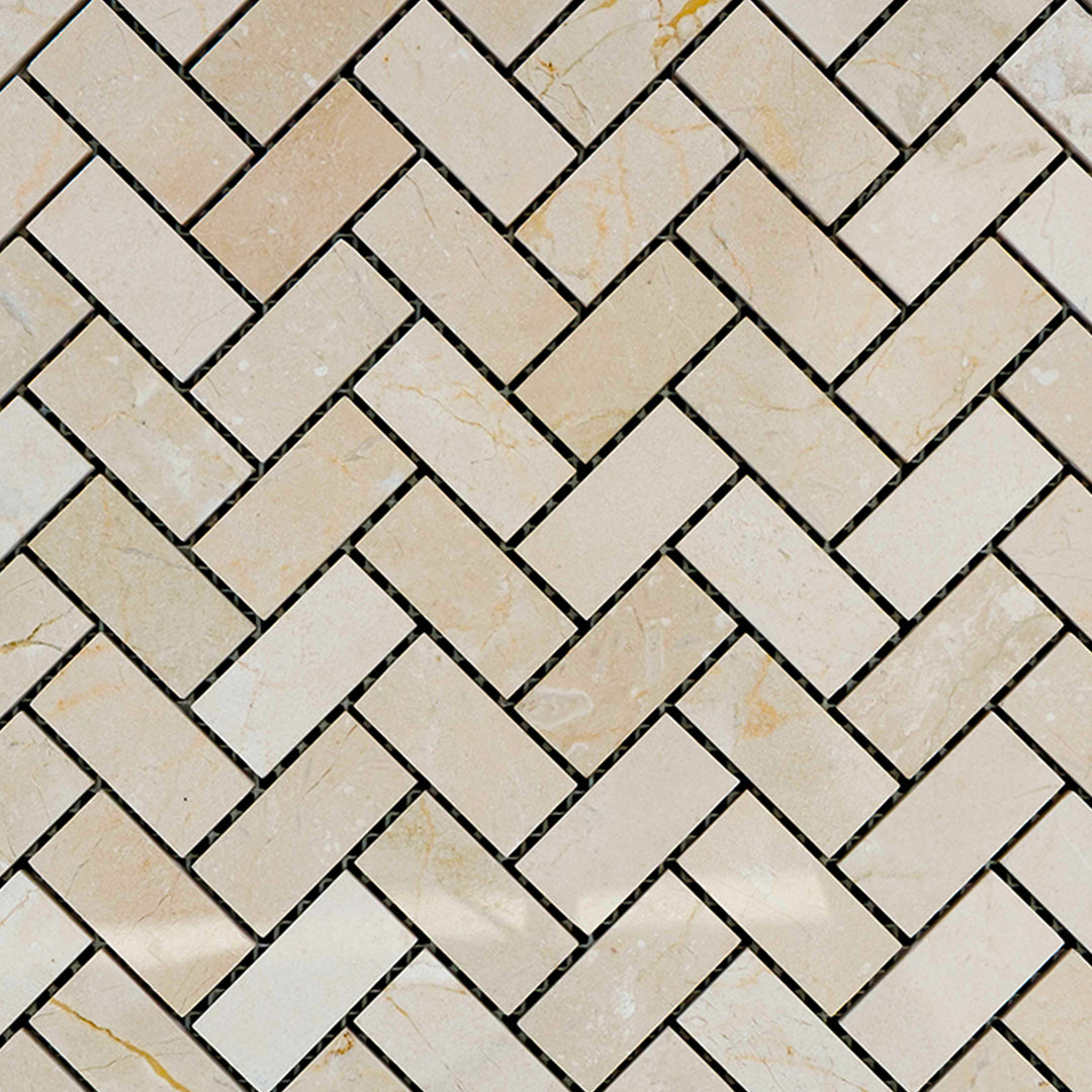 Overview of 1x2 herringbone mosaic using polished Crema Marfil Marble, capturing glossy texture and elegant pattern.