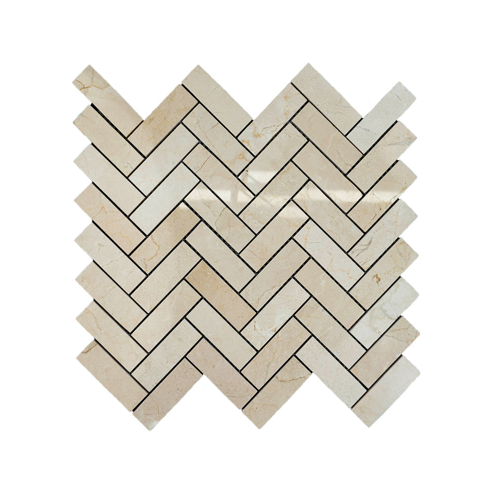 Polished Crema Marfil Marble 1x3 herringbone mosaic seen from above, displaying a refined diagonal layout with glossy beige tones and smooth veining.