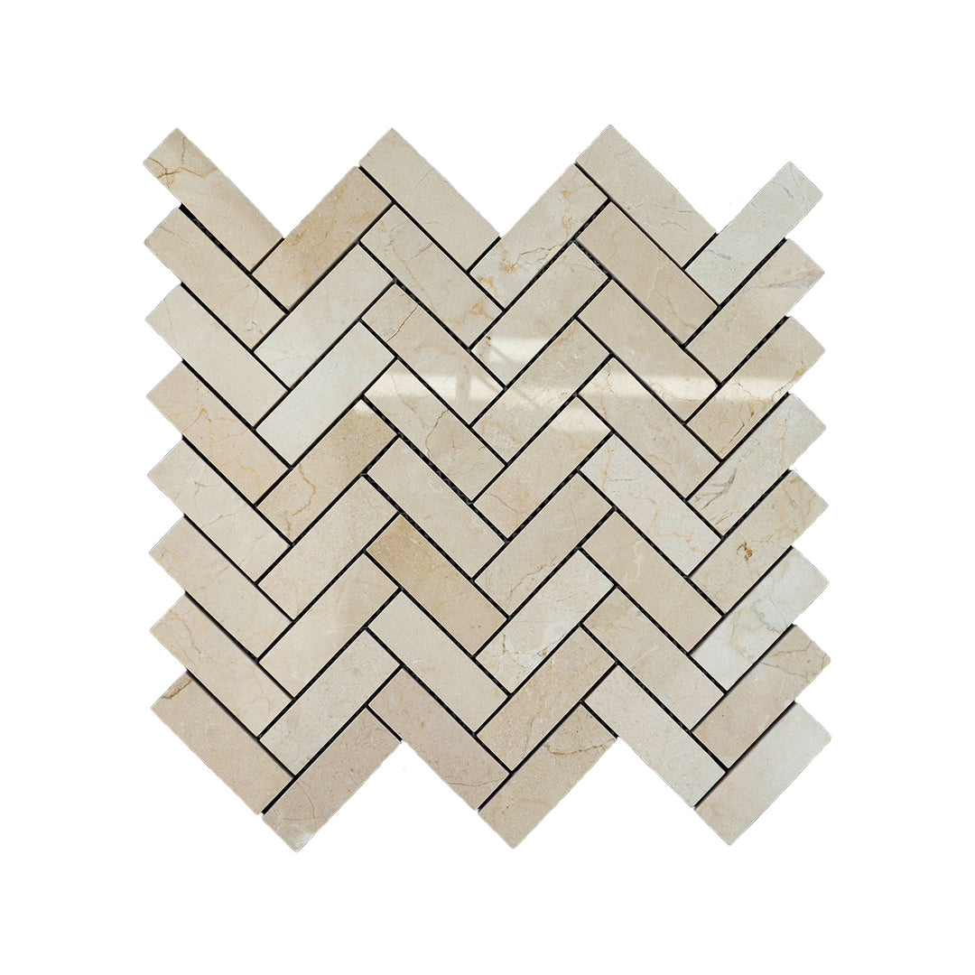 Polished Crema Marfil Marble 1x3 herringbone mosaic seen from above, displaying a refined diagonal layout with glossy beige tones and smooth veining.