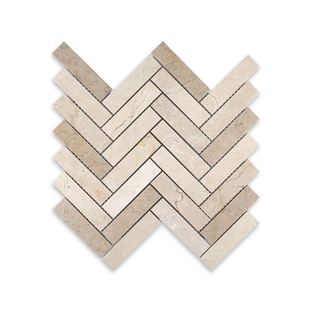 Top-down view of 1x4 herringbone mosaic in honed Crema Marfil Marble, featuring long linear pieces with a soft matte surface and classic style.