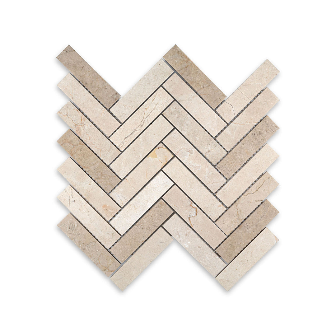 Top-down view of 1x4 herringbone mosaic in honed Crema Marfil Marble, featuring long linear pieces with a soft matte surface and classic style.