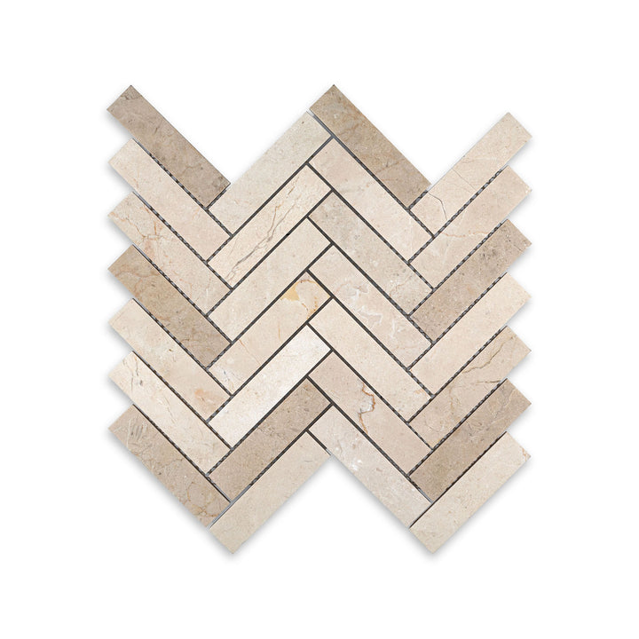 Top-down view of 1x4 herringbone mosaic in honed Crema Marfil Marble, featuring long linear pieces with a soft matte surface and classic style.