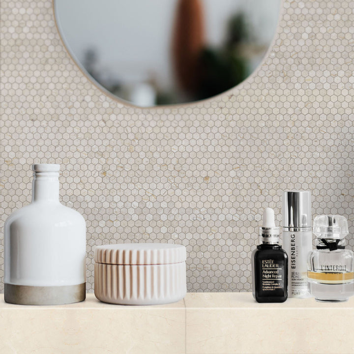 Cosmetic products on a counter with a mirror and tiled wall in the background