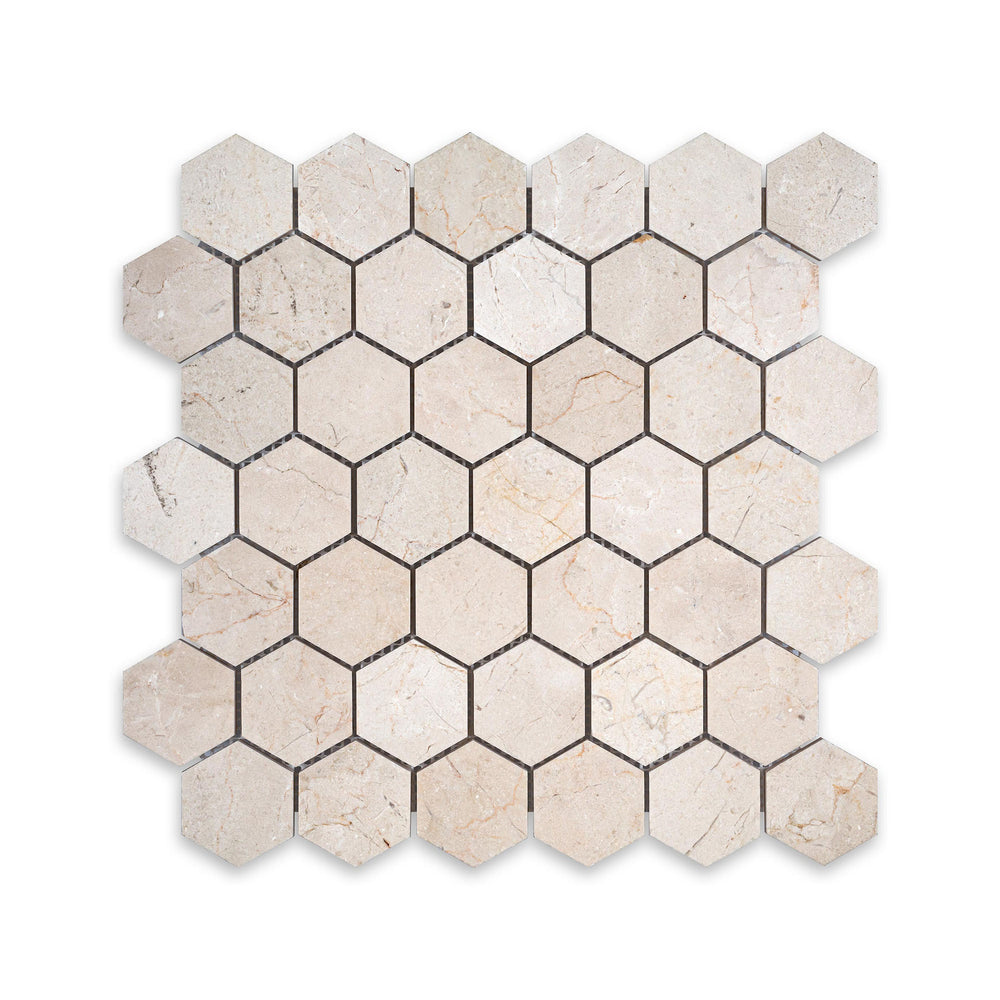 Viewed from above, this 2 inch hexagon mosaic in honed Crema Marfil Marble offers a bold geometric layout with smooth, natural texture.